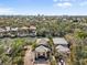 An aerial view of a beautiful canal-front home with a tile roof and lush tropical landscaping at 4964 Commonwealth Dr, Sarasota, FL 34242