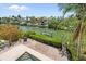 Aerial view showcasing the backyard, waterfront, and surrounding lush landscaping at 4964 Commonwealth Dr, Sarasota, FL 34242