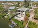 Aerial view of waterfront property with private dock, boat lift, pool and outdoor entertaining space at 4964 Commonwealth Dr, Sarasota, FL 34242