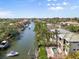 Aerial view overlooking a waterfront property with a boat dock on a scenic canal leading to the ocean at 4964 Commonwealth Dr, Sarasota, FL 34242