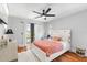 Cozy bedroom with hardwood floors, ceiling fan, and access to a private balcony at 4964 Commonwealth Dr, Sarasota, FL 34242