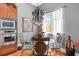 Bright dining area featuring modern chandelier, a glass table, and large windows with natural light at 4964 Commonwealth Dr, Sarasota, FL 34242