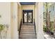 Inviting home entrance with tiled stairs leading to elegant double doors and exterior lighting at 4964 Commonwealth Dr, Sarasota, FL 34242