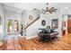 Inviting entryway featuring hardwood floors, staircase, and doorway with lots of natural light at 4964 Commonwealth Dr, Sarasota, FL 34242