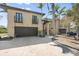 Contemporary two-story home featuring a two-car garage, upper balconies, and manicured landscaping at 4964 Commonwealth Dr, Sarasota, FL 34242