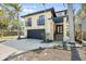 Contemporary home with a two-car garage, second-story balconies, and a landscaped yard at 4964 Commonwealth Dr, Sarasota, FL 34242