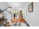 Open foyer with hardwood floors flowing into a living area with large windows and sliding glass doors at 4964 Commonwealth Dr, Sarasota, FL 34242