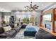 Spacious living area featuring a cozy sectional, large area rug, and natural light at 4964 Commonwealth Dr, Sarasota, FL 34242