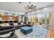 Open concept living space with plush couch, large windows, and seamless flow to the kitchen at 4964 Commonwealth Dr, Sarasota, FL 34242