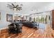 Open-concept space with hardwood floors, a large sectional, and modern bar-style seating area at 4964 Commonwealth Dr, Sarasota, FL 34242