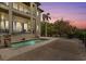 Twilight view of luxurious outdoor pool and patio area at 4964 Commonwealth Dr, Sarasota, FL 34242