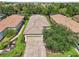 Aerial shot of the property showing a well-manicured lawn, brick driveway, and tile roof at 5019 Serata Dr, Lakewood Ranch, FL 34211