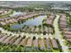 Lakefront homes glisten in this gorgeous aerial view, featuring barrel tile roofs and screened in pools at 5019 Serata Dr, Lakewood Ranch, FL 34211
