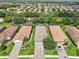 Birds-eye view of barrel-tile roofed homes, lush landscaping, and brick paved driveways in a well planned community at 5019 Serata Dr, Lakewood Ranch, FL 34211
