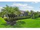 Lush backyard featuring manicured landscaping and a screened in lanai at 5019 Serata Dr, Lakewood Ranch, FL 34211