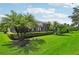 Lush backyard featuring manicured landscaping and a screened in lanai at 5019 Serata Dr, Lakewood Ranch, FL 34211