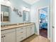 Spacious bathroom featuring double sinks, granite counters, and decorative wall art at 5019 Serata Dr, Lakewood Ranch, FL 34211