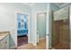 Bathroom view including tile shower, granite counters, and bedroom access at 5019 Serata Dr, Lakewood Ranch, FL 34211