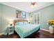 Comfortable bedroom featuring a light blue comforter, ceiling fan, and natural light at 5019 Serata Dr, Lakewood Ranch, FL 34211