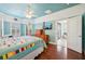 Beautiful bedroom showcasing wood floors, a four-poster bed, natural light from windows, and a ceiling fan at 5019 Serata Dr, Lakewood Ranch, FL 34211