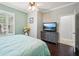 Bedroom features natural light, ceiling fan, hard wood flooring and TV on dresser at 5019 Serata Dr, Lakewood Ranch, FL 34211