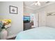 Bright bedroom featuring hard wood flooring, ceiling fan, TV on dresser and decor at 5019 Serata Dr, Lakewood Ranch, FL 34211