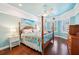 Spacious bedroom features a four-poster bed, hardwood floors, and large windows for natural light at 5019 Serata Dr, Lakewood Ranch, FL 34211