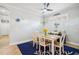 Cozy dining room with a light wood table, white chairs, and stylish decor at 5019 Serata Dr, Lakewood Ranch, FL 34211