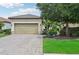 Well-maintained home with a paved driveway, two-car garage, and manicured landscaping at 5019 Serata Dr, Lakewood Ranch, FL 34211
