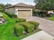 Home exterior showcasing its two-car garage, manicured lawn, and beautiful landscaping at 5019 Serata Dr, Lakewood Ranch, FL 34211
