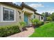Charming home with a beautiful blue door, lush landscaping, and a welcoming brick path at 5019 Serata Dr, Lakewood Ranch, FL 34211