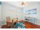 Bright office featuring wood floors, white shutters, and beachy artwork at 5019 Serata Dr, Lakewood Ranch, FL 34211