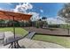 Community playground with a slide, climbing structure, picnic table and shade under a partly cloudy sky at 5019 Serata Dr, Lakewood Ranch, FL 34211