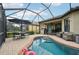 Inviting screened-in pool area with an outdoor dining set and a pink flamingo float at 5019 Serata Dr, Lakewood Ranch, FL 34211
