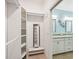 Walk-in closet featuring custom shelving and access to the primary bathroom at 5019 Serata Dr, Lakewood Ranch, FL 34211