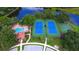 Aerial view of the community pool, tennis and basketball courts, and lake at 5032 Timber Chase Way, Sarasota, FL 34238