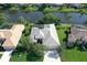 This aerial view showcases a lovely single-story home with a tile roof and screened-in lanai overlooking a serene waterway at 5032 Timber Chase Way, Sarasota, FL 34238