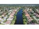 Aerial view of homes lining a waterway, showcasing a community with waterfront properties and lush landscaping at 5032 Timber Chase Way, Sarasota, FL 34238