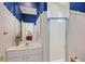 Bathroom featuring bright blue wallpaper, white beadboard, a white sink and a frosted glass shower at 5032 Timber Chase Way, Sarasota, FL 34238