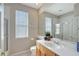 Bathroom featuring a vanity, mirror, shower, and natural light from a large window at 5032 Timber Chase Way, Sarasota, FL 34238