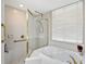 Bathroom featuring bathtub, shower, gold finishes, grab bar, and natural light from the window at 5032 Timber Chase Way, Sarasota, FL 34238