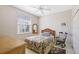 Bedroom with neutral walls, ceiling fan, a window, and a rocking chair at 5032 Timber Chase Way, Sarasota, FL 34238