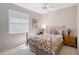 Bedroom featuring a ceiling fan, a colorful bedspread, and neutral walls at 5032 Timber Chase Way, Sarasota, FL 34238