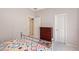 Bedroom features a colorful bedspread, silver metal bed frame and a dark wood dresser at 5032 Timber Chase Way, Sarasota, FL 34238