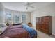 Bedroom featuring a ceiling fan, carpeted floors, bay windows, and a wooden dresser at 5032 Timber Chase Way, Sarasota, FL 34238