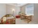 Bedroom with a twin bed, desk, art easel and a ceiling fan for a comfortable and creative space at 5032 Timber Chase Way, Sarasota, FL 34238