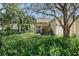 Charming front entrance is surrounded by lush landscaping; the home has neutral paint and trim at 5032 Timber Chase Way, Sarasota, FL 34238