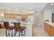 Bright kitchen with white countertops, light wood cabinets, and bar stool seating at 5032 Timber Chase Way, Sarasota, FL 34238