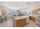 Open kitchen features a large island, white appliances, and a breakfast nook with views at 5032 Timber Chase Way, Sarasota, FL 34238