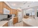 Functional kitchen with white appliances, wood cabinets, and seamless flow to the dining area at 5032 Timber Chase Way, Sarasota, FL 34238